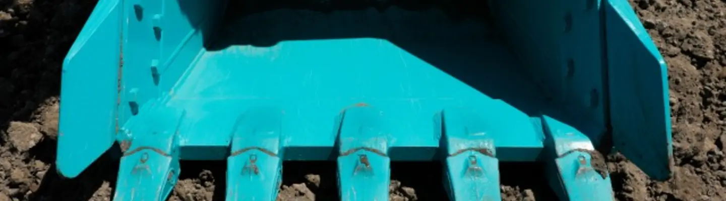 A drum roller compacting soil on a construction site to prepare a stable surface for building or roadwork.