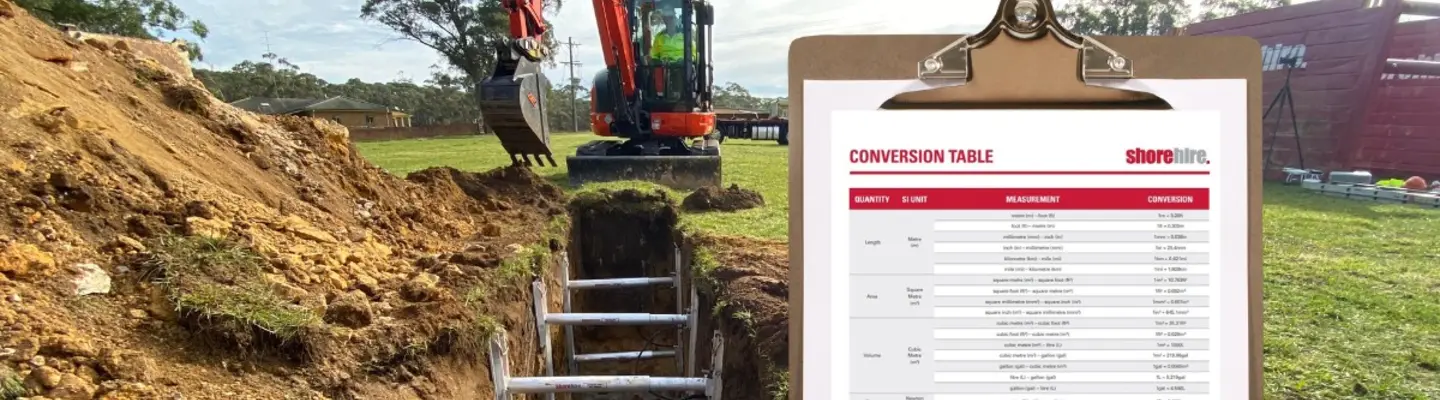 Construction machine near a trench with a conversion table displayed, aiding in accurate measurements and safe installation.