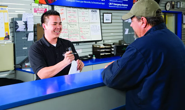 man at counter making payment