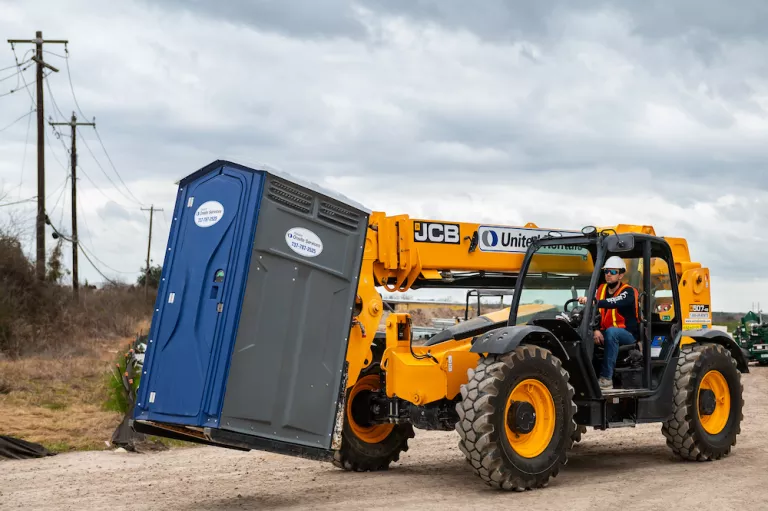 forklift moving porta potty