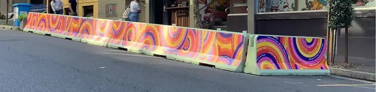 art painted concrete barriers on side street
