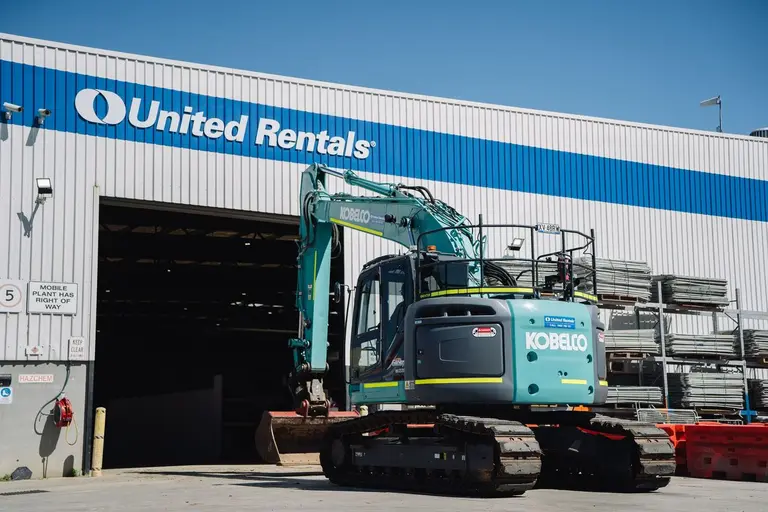 excavator in from of the hangar