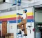 Blue Genie 650 lb. manual material lift with ladder in use lifting ductwork