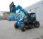 Blue Genie 6,000 lb. telehandler reach forklift parked outside of a building with other forklifts in the background