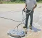 Black Mi-T-M 3,000 pressure washer rotary wash brush being used to clean concrete