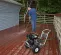 Black Mi-T-M 2,700 psi pressure washer being used to clean wood deck boards