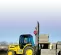 yellow rough terrain forklift lifting materials outside