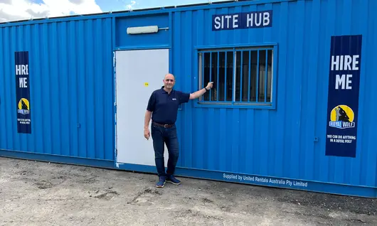 Man standing in front of blue Site Hub shipping container.