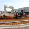 White and red TAKEUCHI 14,000-18,000 lb. Mini Excavator, Reduced Tail Swing