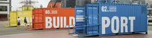 Various shipping containers on display at an exhibit, showcasing innovative container designs and applications.