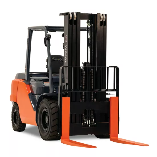 Front angled view of an orange and black Toyota warehouse forklift with a black mast, orange forks and an open cabin.