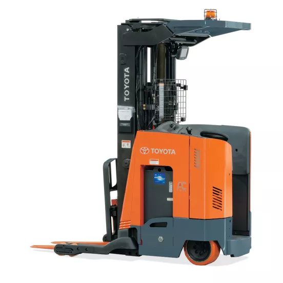 Side view of an orange and black stand-up electric Toyota warehouse forklift with orange forks and a black mast.