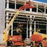 Articulating Boom Lift Extending In Building Site