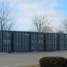 Multiple gray storage containers lined up side-by-side