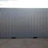 Side angle of gray cargo container on the ground