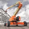 Orange JLG diesel powered articulating boom lift at a job site