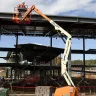 Orange JLG 34 ft. extended articulating boom lift at a job site