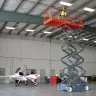 Orange and Gray Skyjack Electric Powered Scissor Lift on a job site
