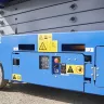 Blue Genie 24-26 ft. wide electric scissor lift on asphalt