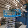 Blue Genie 39-40 ft. wide electric scissor lift inside a warehouse