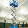 Blue Genie 39-40 ft. electric scissor lift extended inside gymnasium