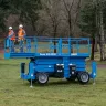 Blue Genie 36-49 ft. Scissor Lift with 4WD in the grass near trees
