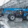 Blue Genie 6,000 lb. telehandler reach forklift preparing to lift a load in a warehouse