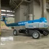 Blue Genie 125 ft. 4WD telescopic boom lift  in a manufacturing plant