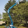 Blue Genie 30-36 ft. towable extended boom lift being used for tree trimming