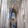 Blue Genie 30-36 ft. towable extended boom lift in use inside a cathedral