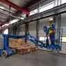 Blue Genie 30 ft. extended electric articulating boom lift in use in a warehouse