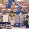 Blue Genie 30 ft. extended electric articulating boom lift in use in a manufacturing facility