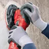 Red and black Hilti 5 in. electric disc grinder in use