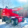 Red and black Magni 11,000-13,200 lb. variable reach forklift in the snow