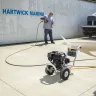 Black Mi-T-M 2,700 psi pressure washer being used to clean a concrete parking lot