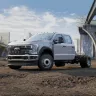 White Ford 1-ton pickup truck with 4-wheel drive and an extended cab with bed detached at a construction site