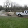 Beige Finncorp Hydroseeder in use by a worker on the grass