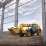 Yellow and black Telehandler Reach with forklift lowered driving onto jobsite